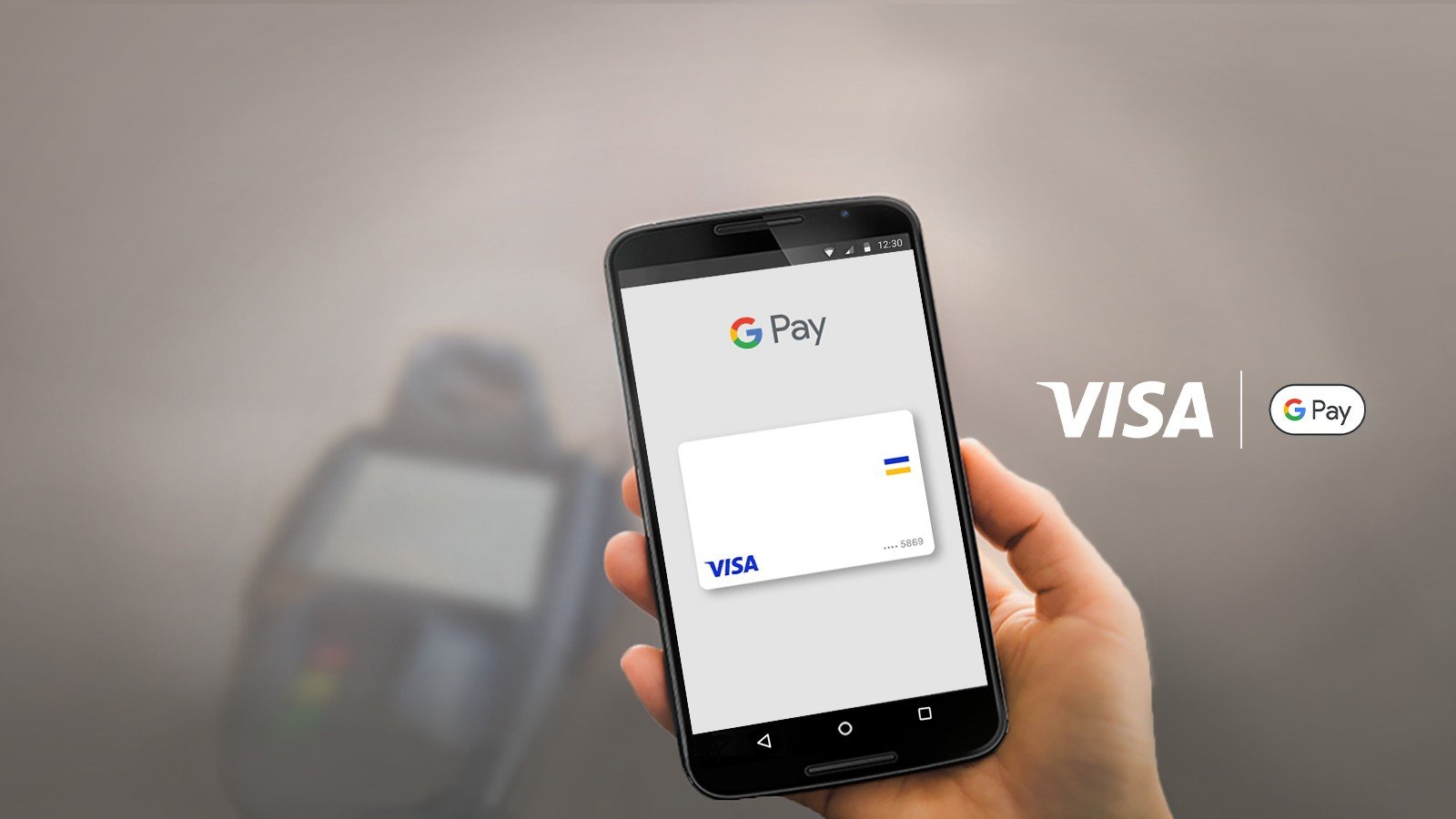 holding phone next to visa gpay logo